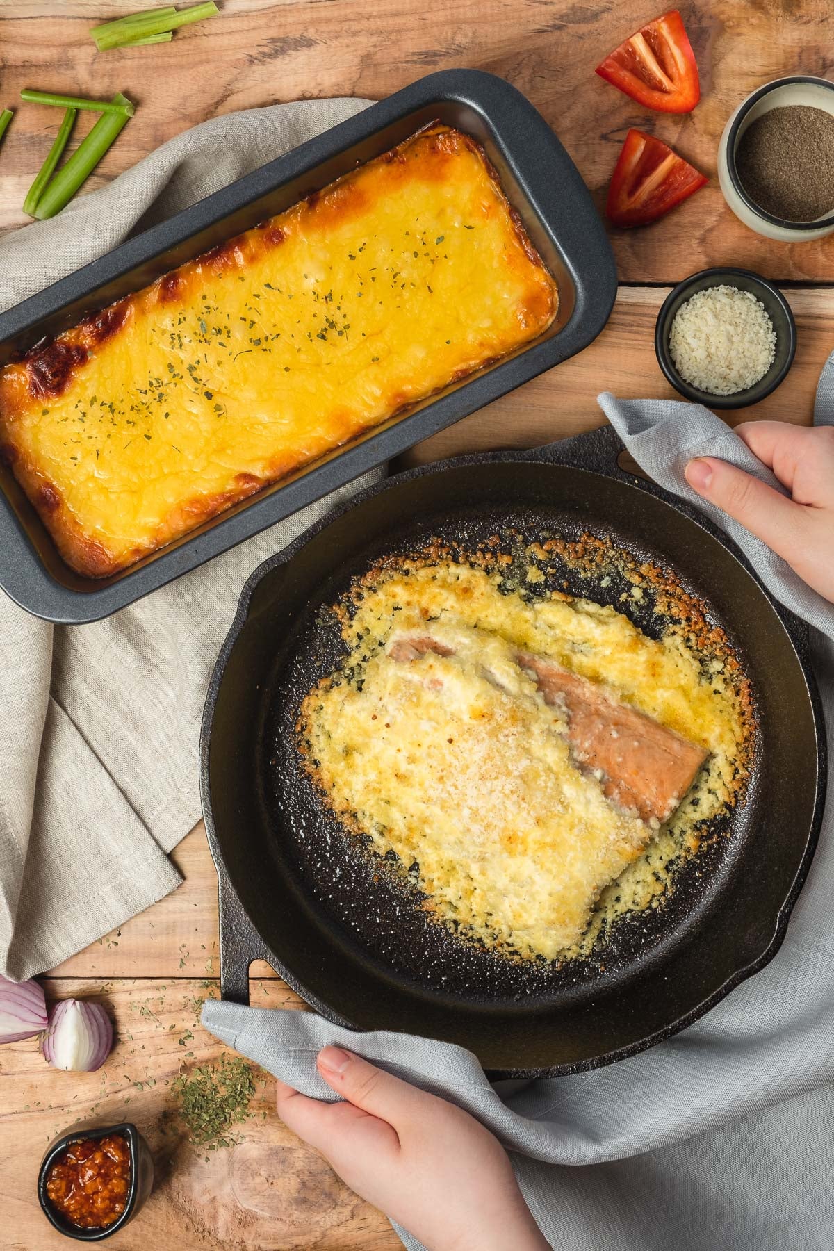 Natural linen tea towel beneath baking pan (protects countertop) and gray linen dish towel as pot holder (protects hands against heat)