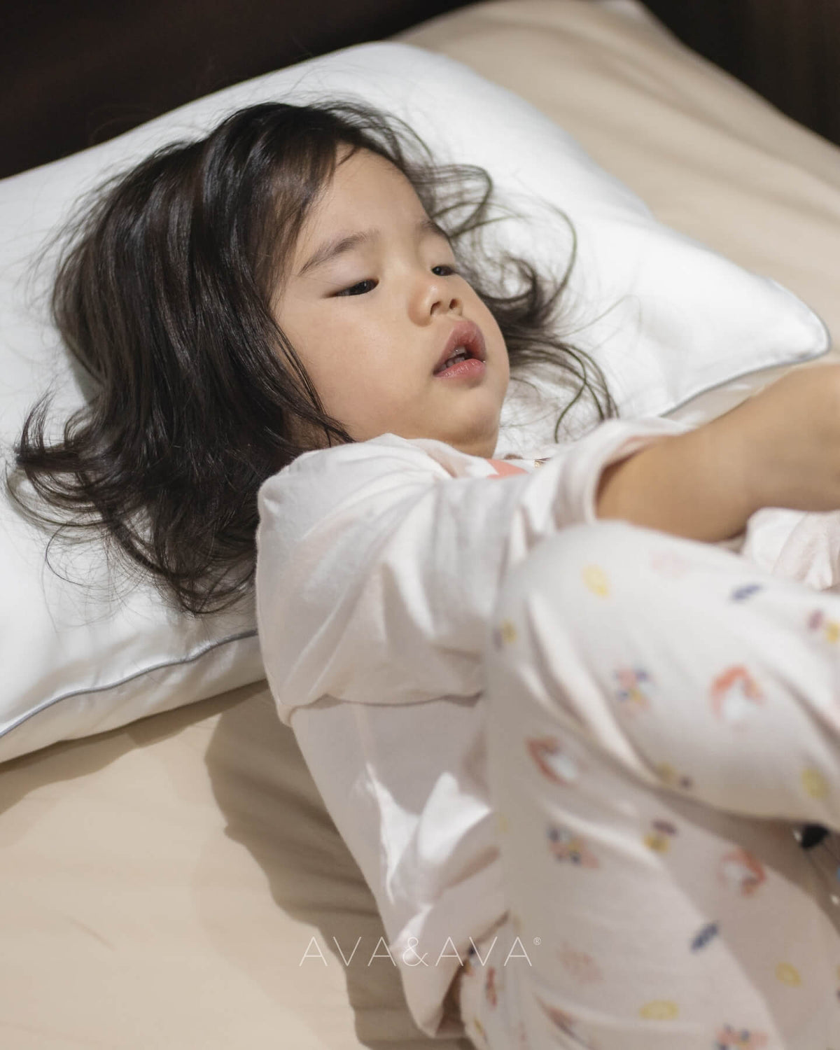 ava and ava ph organic bamboo lyocell hypoallergenic toddler pillow with white pillowcase with gray piping with baby lying in bed