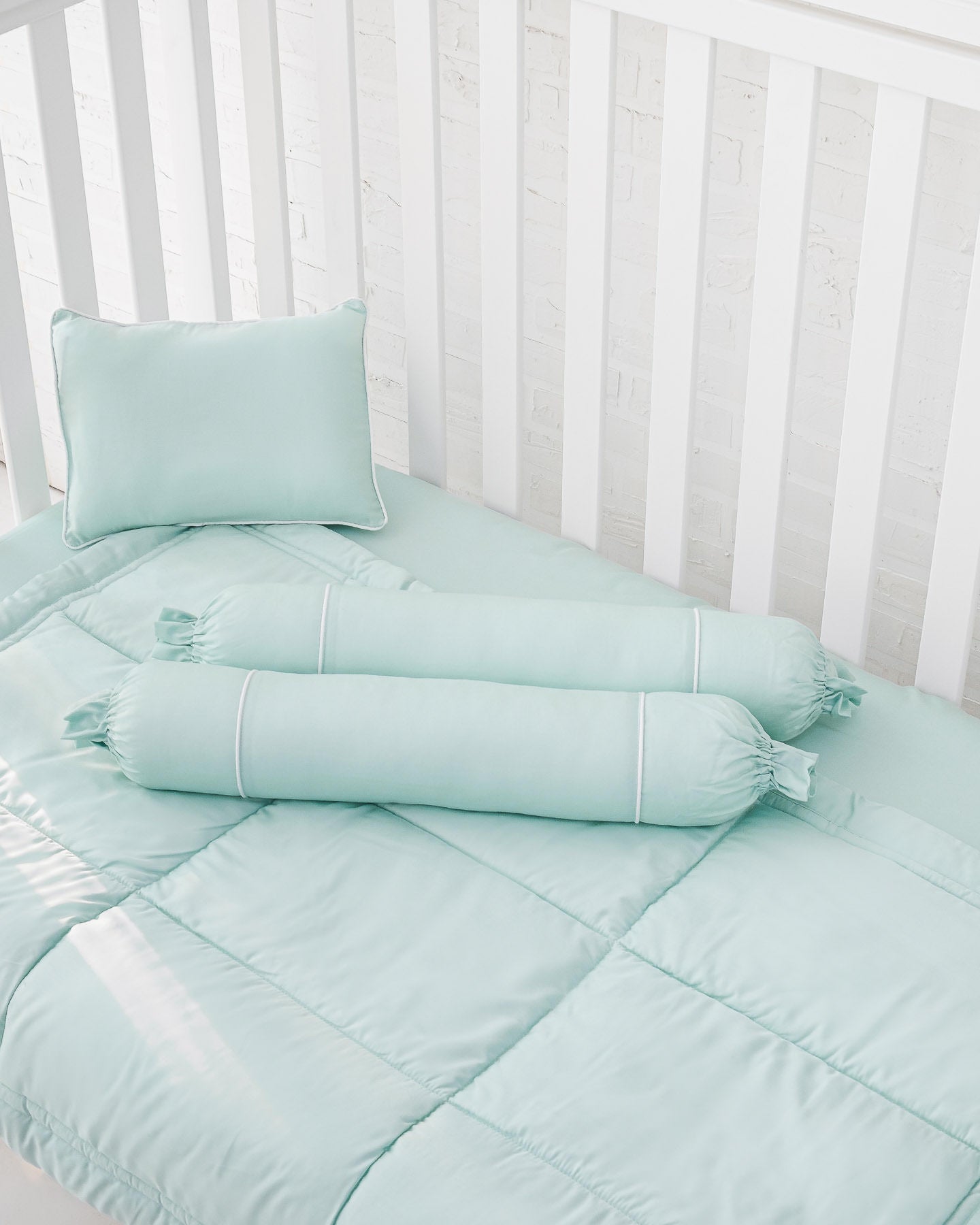 White crib with mint green organic bamboo lyocell baby bedding (baby comforter set - 1 pillowcase, 2 bolstercases, 1 comforter; baby pillow set - 1 headshaping pillow, 2 bolsters; crib fitted sheet)