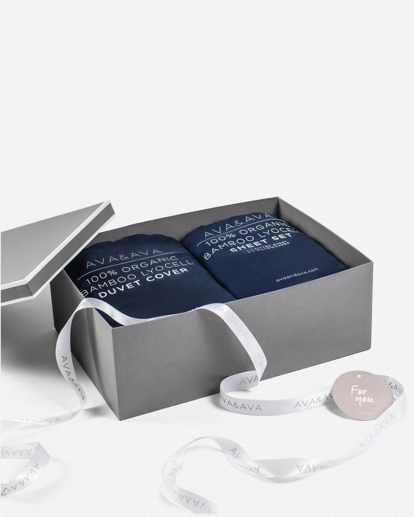 medium gray gift box with white piping, white satin ribbon and card, organic bamboo lyocell sheet set and duvet cover in navy inside. gift for mothers day / fathers day / birthday / wedding / grandparents