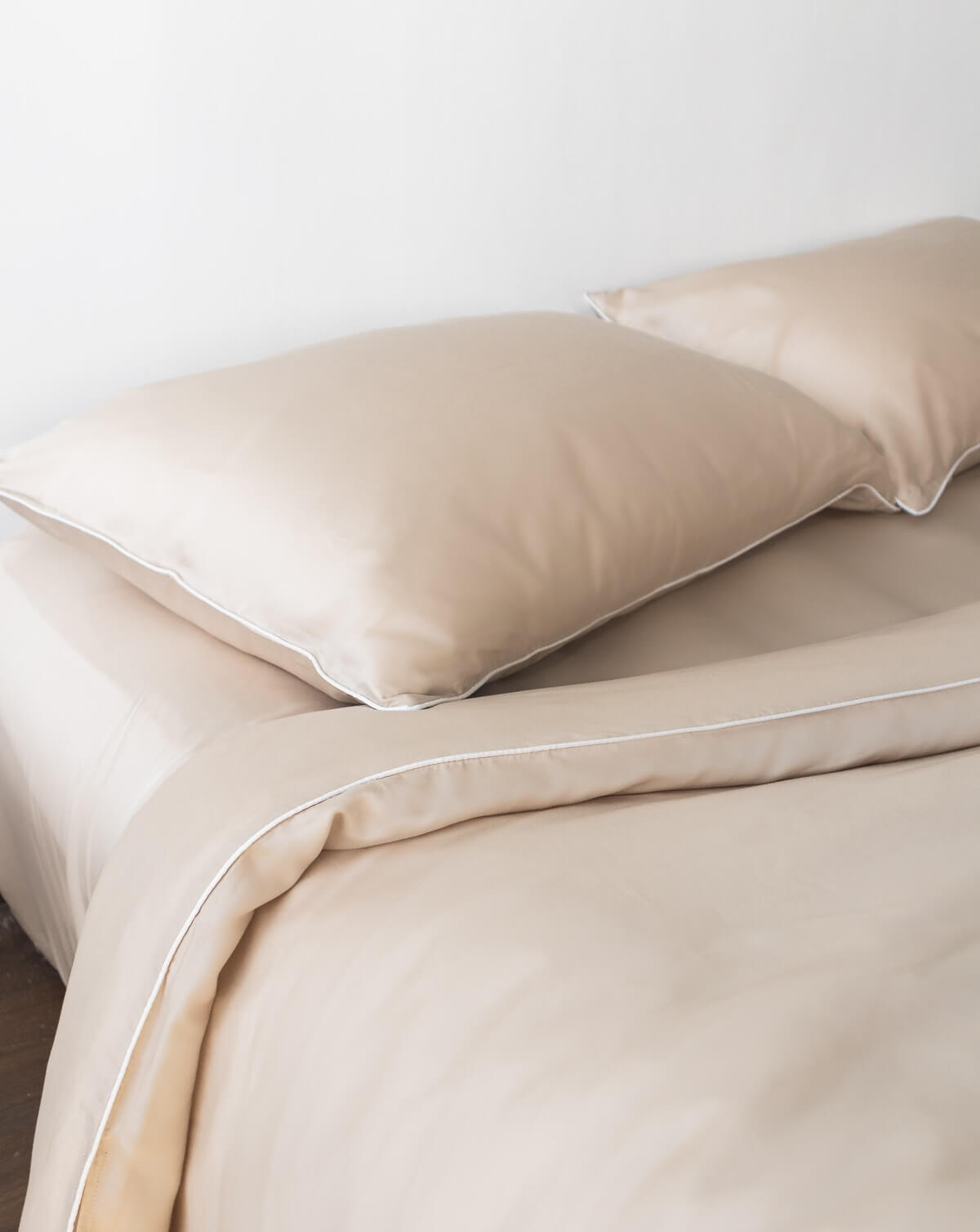 ava and ava ph organic bamboo lyocell duvet cover sheet set pillowcases in sand beige with white piping. soft and cooling bedding sheets.