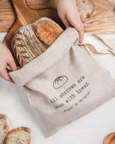 ava and ava ph Sourdough loaf inside natural colored pure linen bread bag with black print - All sorrows are less with bread. - Miguel de Cervantes