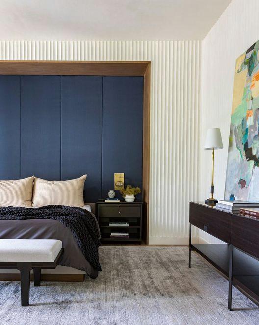 bedroom with navy blue accent wall
