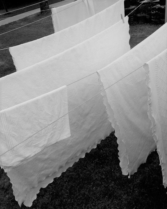 white sheets hanging on laundry line