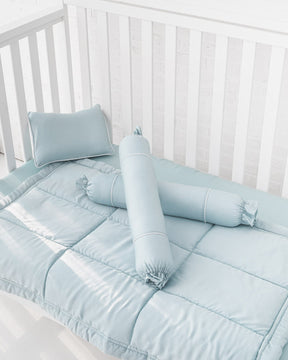 White wooden crib with light blue organic bamboo lyocell baby bedding (baby comforter set - 1 pillowcase, 2 bolstercases, 1 comforter; baby pillow set - 1 headshaping pillow, 2 bolsters; crib fitted sheet)