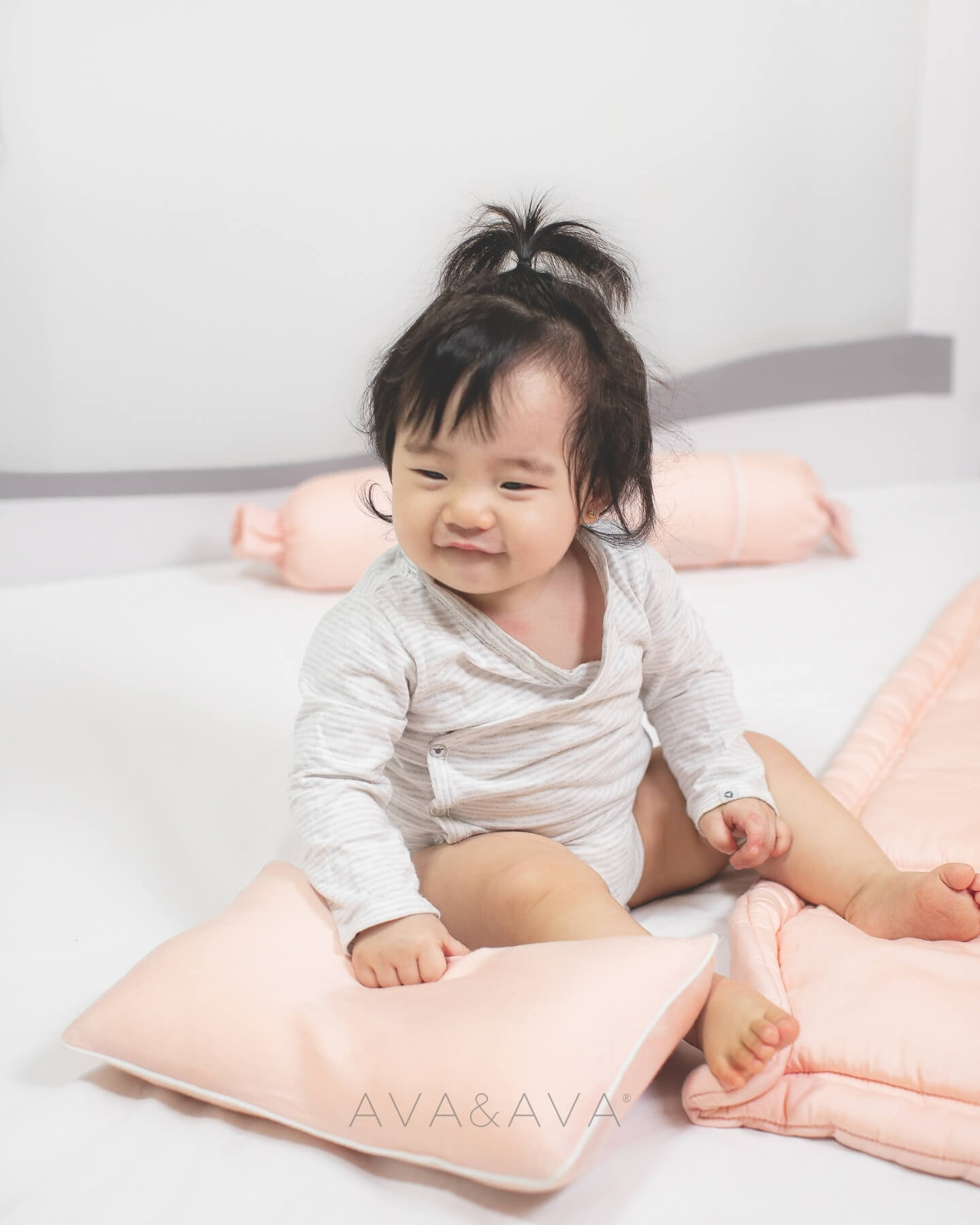 ava and ava baby holding organic bamboo lyocell baby pillowcase set - pillowcase, 2 bolstercases in daydream blush (pink with white piping)
