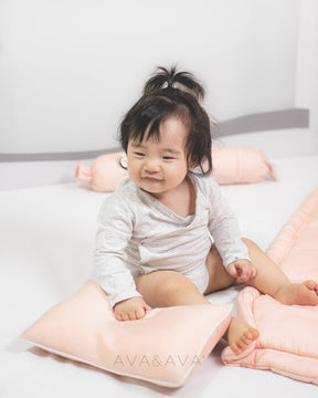 ava and ava baby holding organic bamboo lyocell baby pillowcase set - pillowcase, 2 bolstercases in daydream blush (pink with white piping)