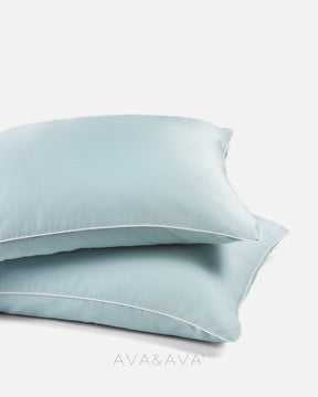 pair of organic bamboo lyocell pillowcases with SKY BLUE WITH WHITE piping. ava and ava ph vegan silk, soft, cool, smooth, breathable pillowcases.
