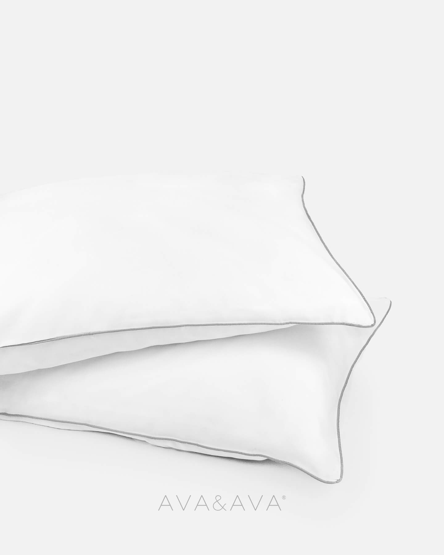 pair of organic bamboo lyocell pillowcases with WHITE WITH GRAY piping. ava and ava ph vegan silk, soft, cool, smooth, breathable pillowcases.

