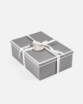 gray gift box with white piping, white satin ava and ava ribbon and gift tag