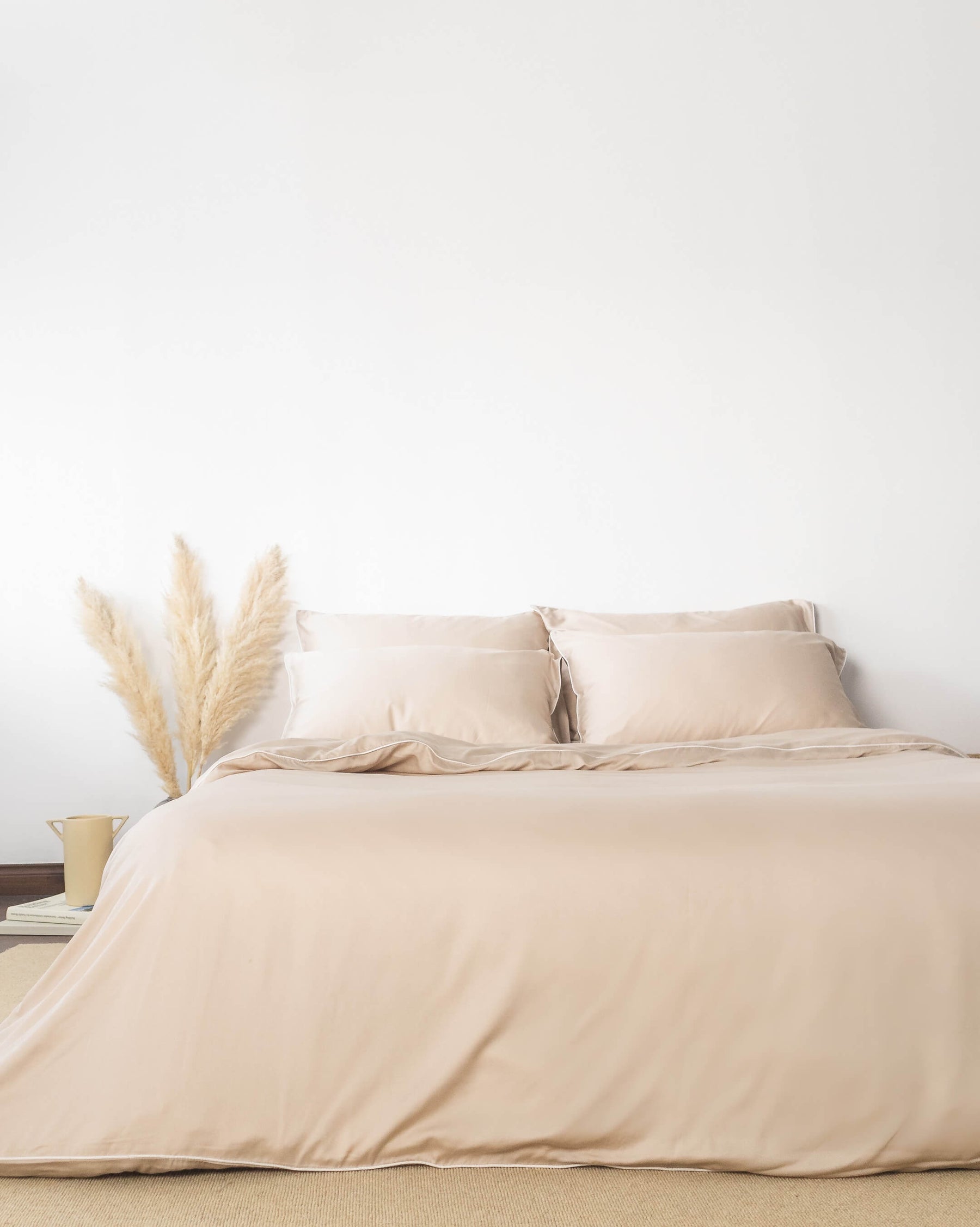 ava and ava ph organic bamboo lyocell duvet cover sheet set pillowcases in sand beige with white piping decorated with pampas summer vibes. soft and cooling bedding sheets.