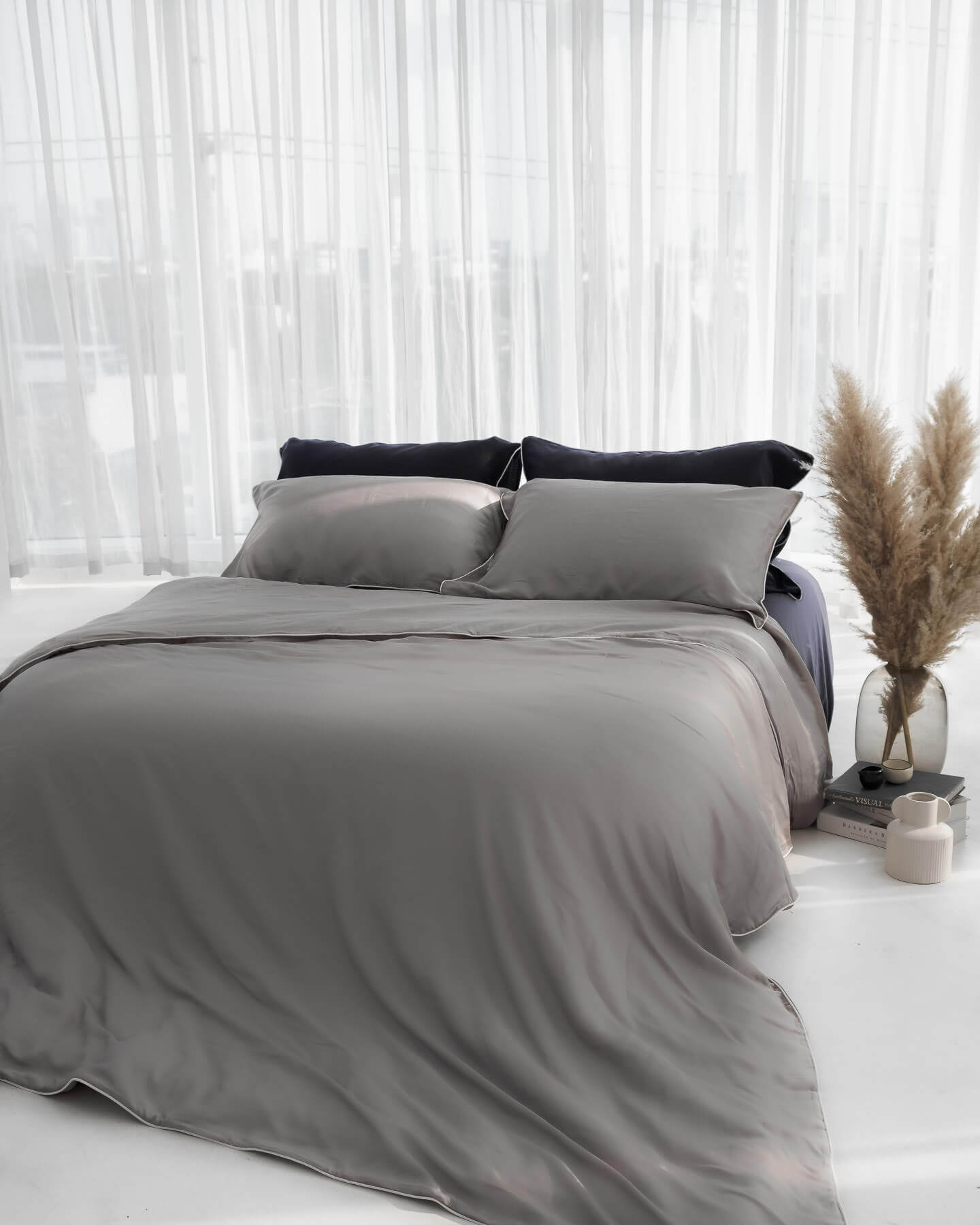 organic bamboo lyocell duvet cover and sheet set (fitted sheet and pillowcases) in urban oasis (gray with white piping) and ocean (navy with white piping). ava and ava ph soft and cooling bedding sheets.
