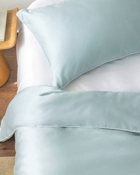 ava and ava ph organic bamboo lyocell duvet cover and sheet set (fitted sheet and pillowcases) in powder blue (sky blue with white piping) and white fitted sheet. soft and cooling bamboo bedding set.