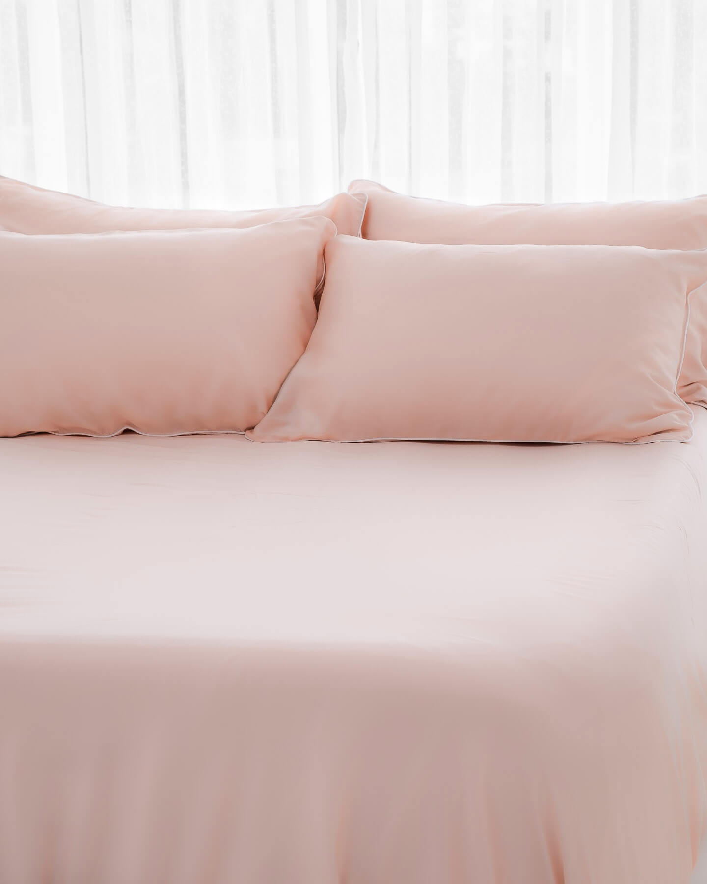 organic bamboo lyocell sheet set (2 pillowcases 1 fitted sheet) in daydream blush (pink with white piping). ava and ava ph soft, cooling, breathable bed sheets.