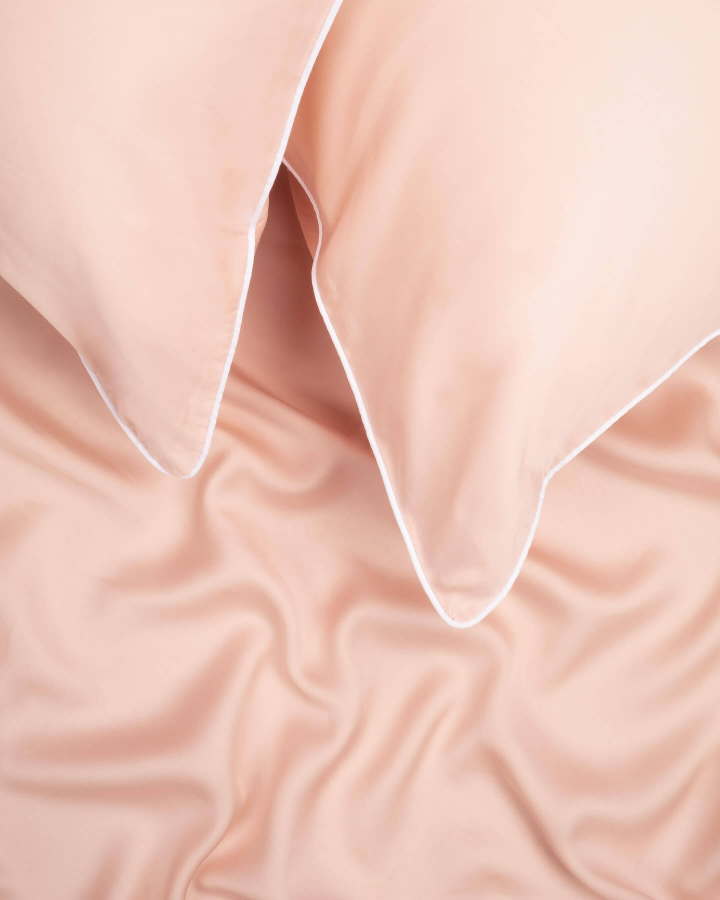 organic bamboo lyocell sheet set (2 pillowcases 1 fitted sheet) in daydream blush (pink with white piping). ava and ava ph soft, cooling, breathable bed sheets.