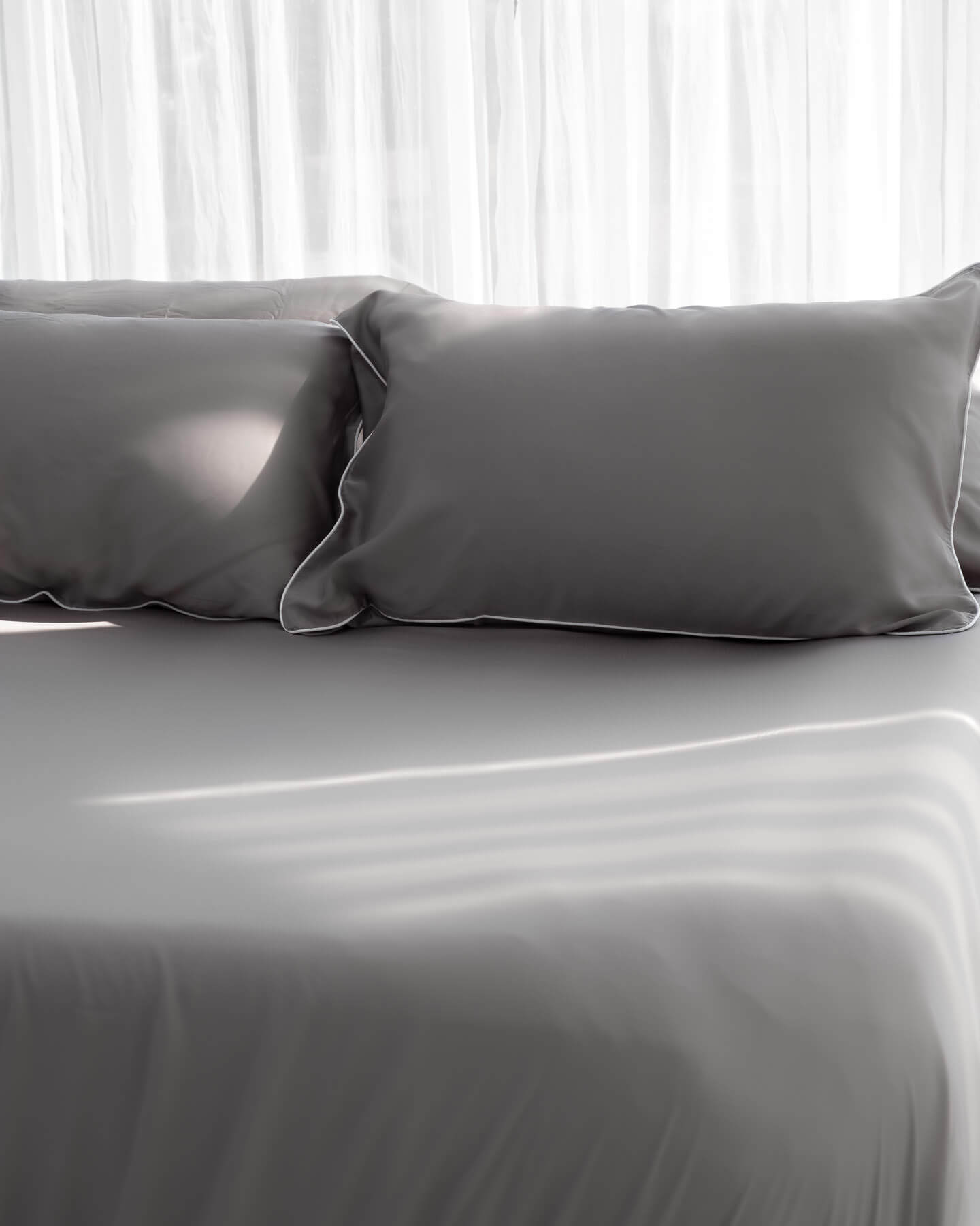 ava and ava ph organic bamboo lyocell sheet set (2 pillowcases 1 fitted sheet) in urban oasis (gray with white piping). ava and ava ph soft, cooling, breathable bed sheets.