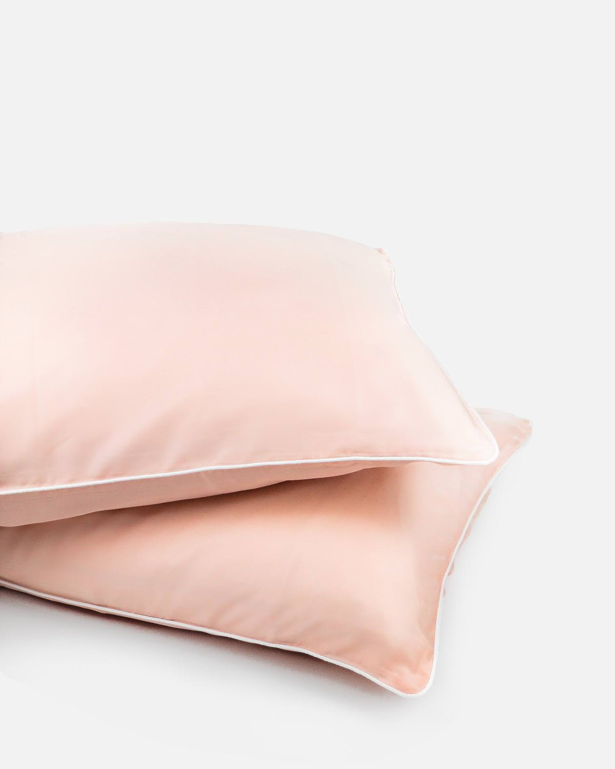 ava and ava ph organic bamboo lyocell pillowcases sand pink with white piping. vegan silk, soft, cool, smooth, breathable.