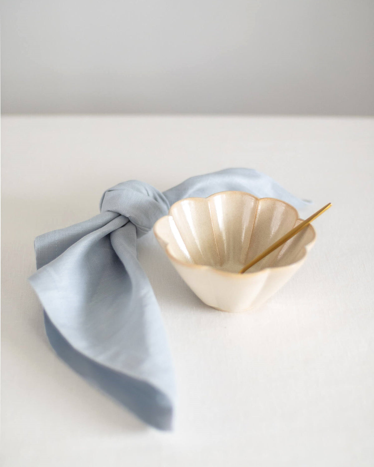 ava and ava ph Light sky blue pure linen table napkin on white plate, knotted