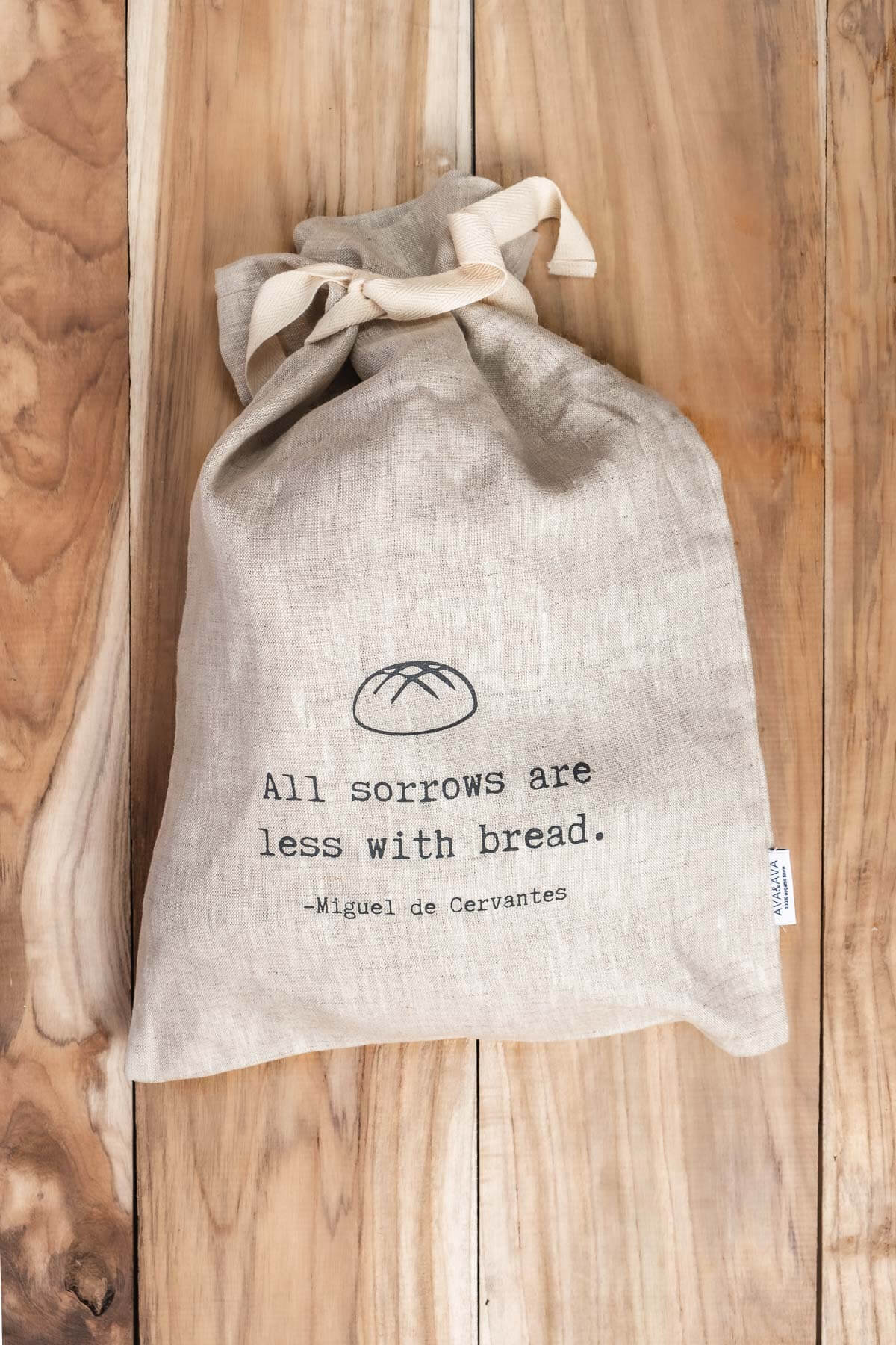 ava and ava ph Sourdough loaf inside natural colored pure linen bread bag with black print - All sorrows are less with bread. - Miguel de Cervantes
