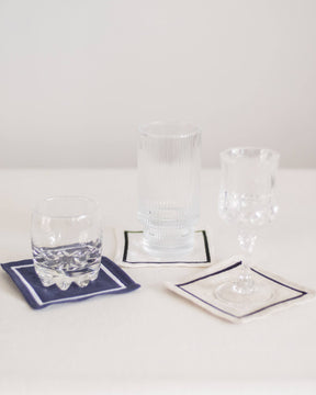 ava and ava organic pure linen embroidered coasters set  white natural navy with glasses drinks