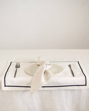 ava and ava ph White pure linen placemat with black embroidered border, with white linen napkin, white plate, silver wood cutlery