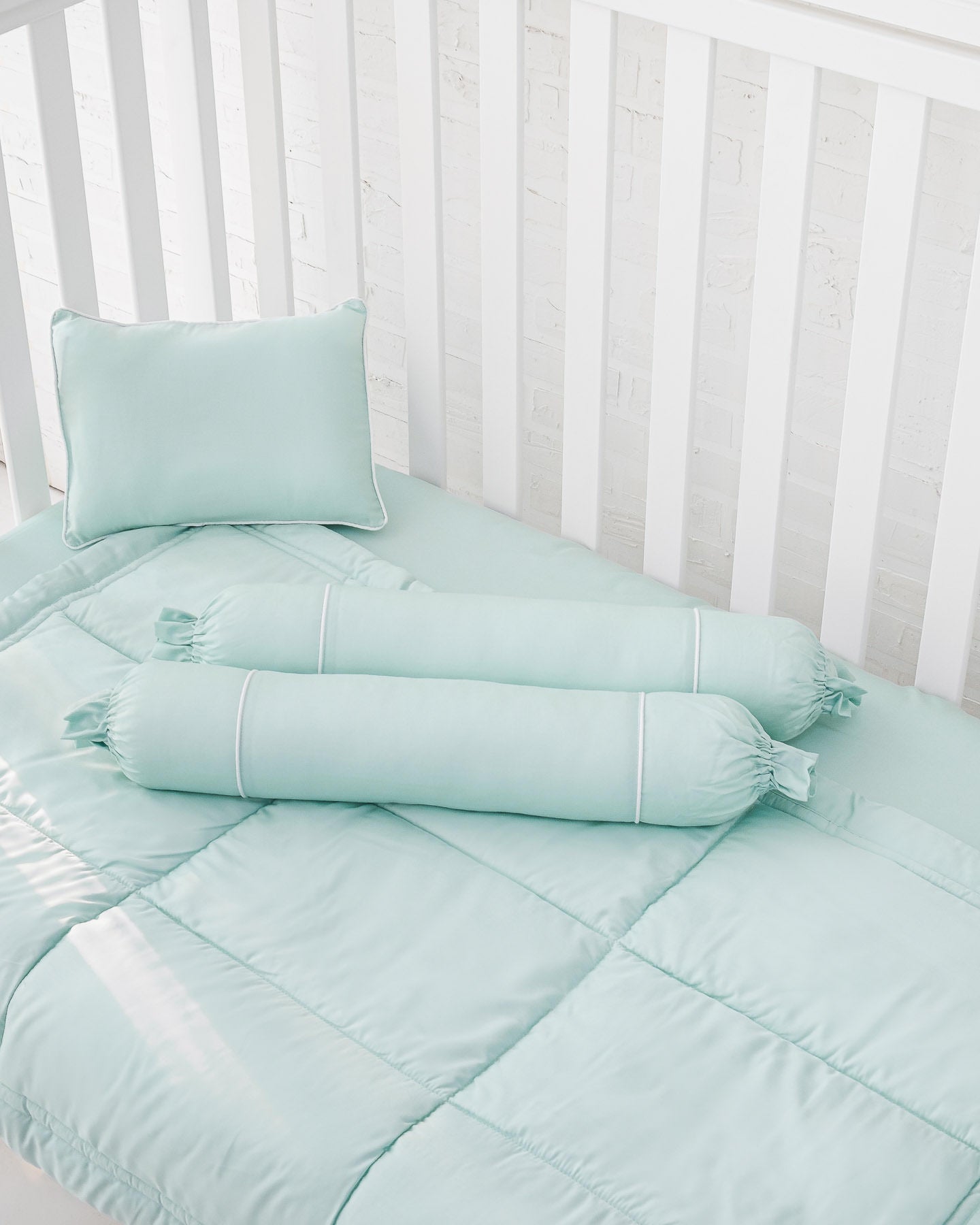White crib with mint green organic bamboo lyocell baby bedding (baby comforter set - 1 pillowcase, 2 bolstercases, 1 comforter; baby pillow set - 1 headshaping pillow, 2 bolsters; crib fitted sheet) 